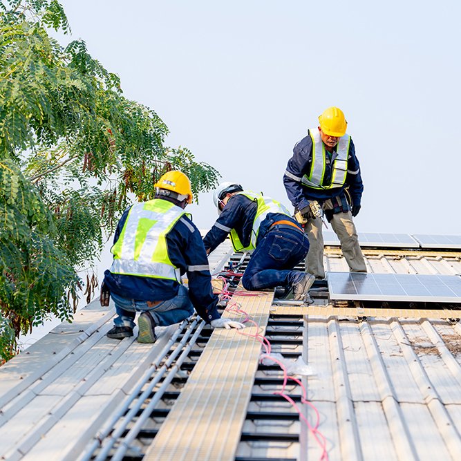 workers installing solar panels, for efficient energy on rooftop